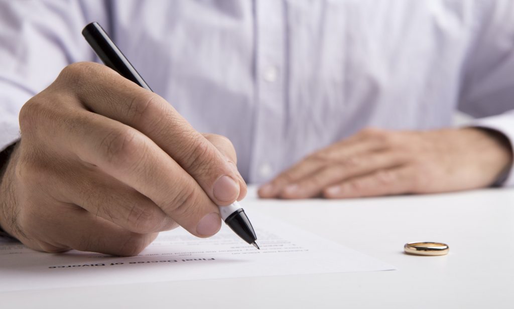 Husband sign divorce decree ending relationships with wife